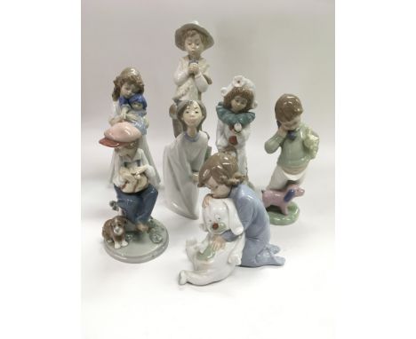 Two Lladro figures of children together with five Nao examples (7).