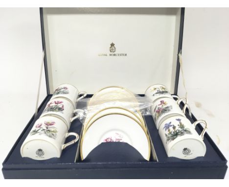 A Royal Worcester porcelain presentation coffee set decorated with flowers.