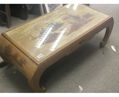 A Chinese hardwood table of rectangular shape with scroll supports.