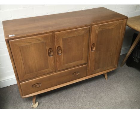 A modern design Ercol light medium elm side board with cupboards and a drawer on splayed legs. 115cm x44cm
