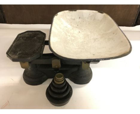 A Set of metal Shop Scales with Weights.
