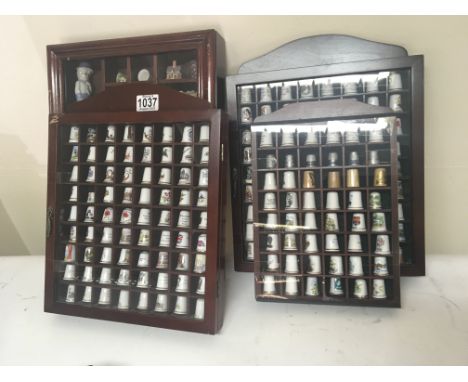 A large collection of ceramic and porcelain sewing thimbles in display cases boxes an extensive collection.