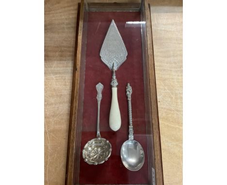 Good display case containing a white metal trowel inscribed â€œpresented to miss R A Hunt on occasion of laying one of the me