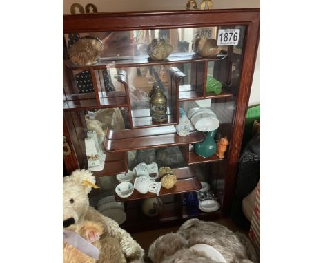Two Chinese hardwood hanging display cabinets containing carved Netsuke and other oddments.