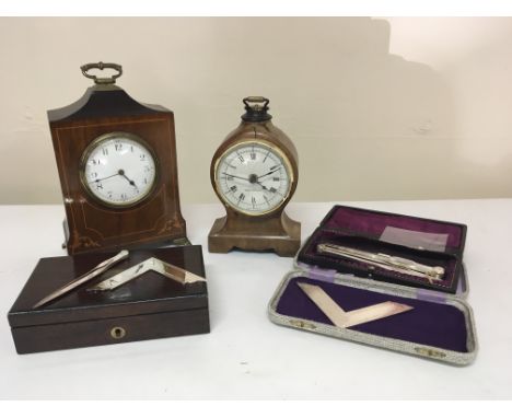 An Edwardian inlaid mahogany mantel clock a walnut clock and a quantity of silver plated Masonic tools (a lot)