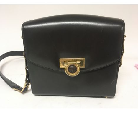 A Vintage Gianni Versace bag brown leather with a gilt metal answer simulated bronze Louis XV style clasp.