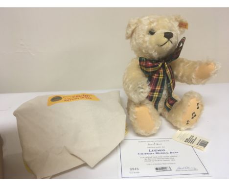 A Steiff Ludwig musical bear with certificate of authenticity number 945 and dust bag in excellent condition.