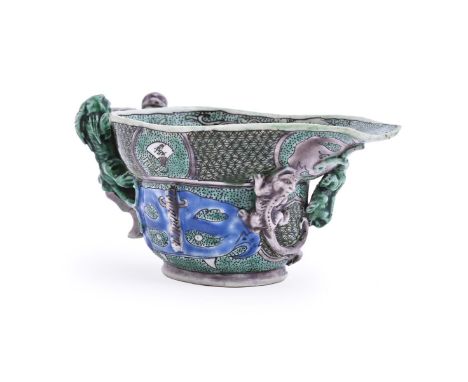 A Chinese Famille Verte libation cup, Kangxi, applied with twin chilong handle and two further chilong near the spout, painte