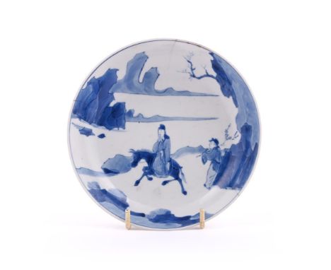 A Chinese blue and white saucer dish, mark of Kangxi and of the period, painted with an equestrian scholar riding a donkey, w