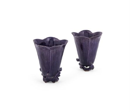 A pair Chinese of manganese-purple cups, Kangxi, of flower form standing on branch and bud feet, 9.5cm high (2)Compare with a