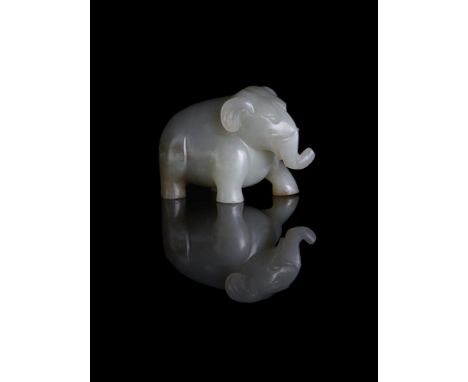 A Chinese pale celadon and russet jade Elephant, Qing Dynasty, standing facing forward, with incised details, 8cm long x 5cm 