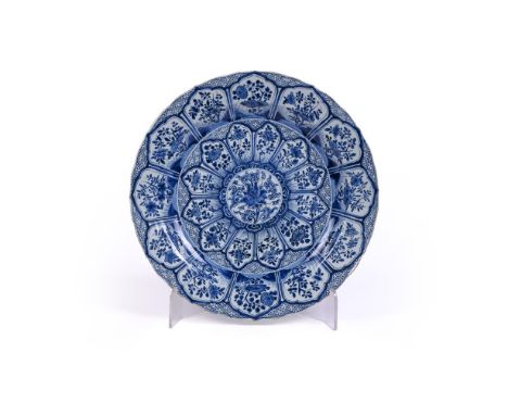 A large Chinese blue and white dish, Kangxi period, decorated with a lotus flower in the centre surrounded by a ruyi-border a