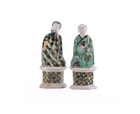 Two Chinese Famille Verte figures of the Immortals Zhong Li Quan and Lan Cai He, Kangxi, coloured with green, yellow, black a