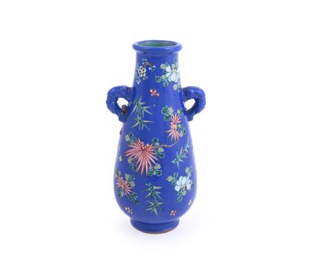 A Chinese yixing enamelled twin handled vase, 19th century, the body covered with bright blue enamel and decorated with flowe