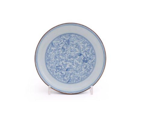 A Chinese blue and white 'lion' dish, Kangxi, the centre painted with three Buddhist lions spaced amongst foliage within doub