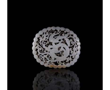 A Chinese pale celadon jade reticulated 'Dragon' plaque, Qing Dynasty, the oval plaque carved in openwork with a dragon in fl