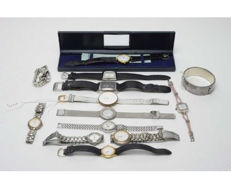 An Elizabeth II silver hinged bangle, and a collection of 20th Century predominantly womens' dress watches, including brands 