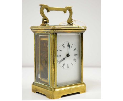 A late 19th/early 20th C brass carriage clock, approximately 15cms high overall (including handle).
