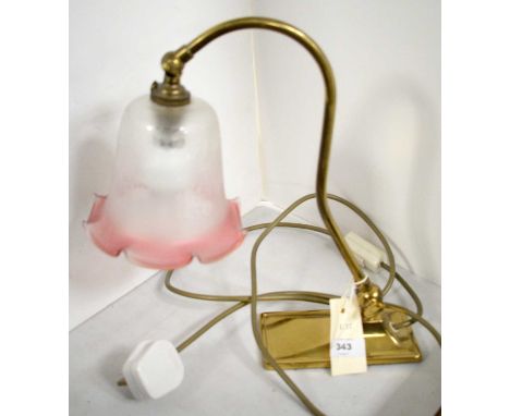 An early 20th Century brass desk lamp, with clear opaque and pink glass shade, 52cms high.