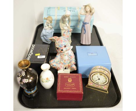 A selection of decorative ceramics, including: a Lladro figure of a girl; a Nao figure of girl holding a puppy; another spani