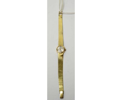 A lady's 14ct gold cased Longines cocktail watch, with manual-wind movement, baton markers and a silvered dial, on a 14ct gol