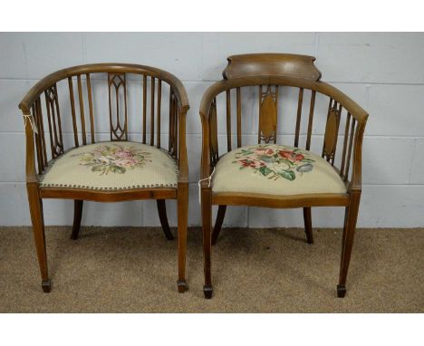 Two Edwardian inlaid mahogany occasional chairs, with railing and pierced back, the seat cushions upholstered in floral patte