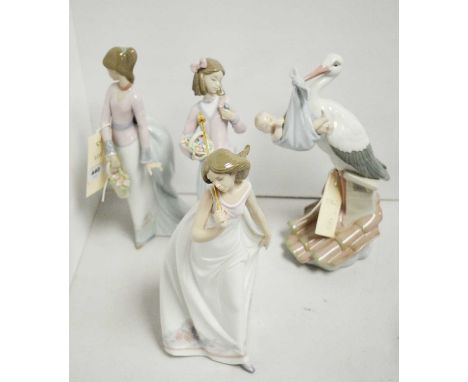 A Lladro figure of a stork carrying a baby, poised upon a rooftop, 25cms high; together with three Lladro figures of girls. (