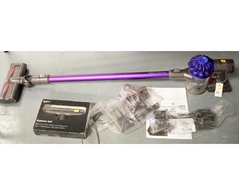 A Dyson V6 Animal cordless vacuum cleaner/hoover, with manual, charging cord, wall mounting stand, and attachments, including