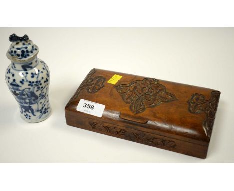 An early 20th Century carved mahogany cigarette box, the hinged lid and sides carved with foliate motifs, 19cms wide; togethe