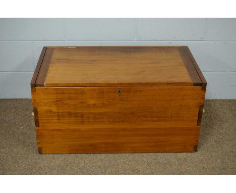 A teak trunk with ropework handles, 90cms wide.