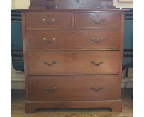 An Edwardian mahogany and cross banded chest of two small and three graduated drawers with carved brass drop handles, shaped 