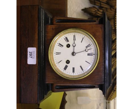 An Edwardian mahogany and lacquered mantle clock with shaped cornice, circular porcelain dial on a shaped plinth, 22cm x 23cm