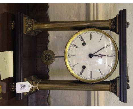 A 19th century style Odo mantle clock, raised on four brass fluted Corinthian columns, circular porcelain dial with Roman num