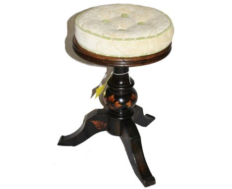 A Victorian mahogany circular adjustable piano stool with upholstered seat, raised on a baluster shaped support with lacquere