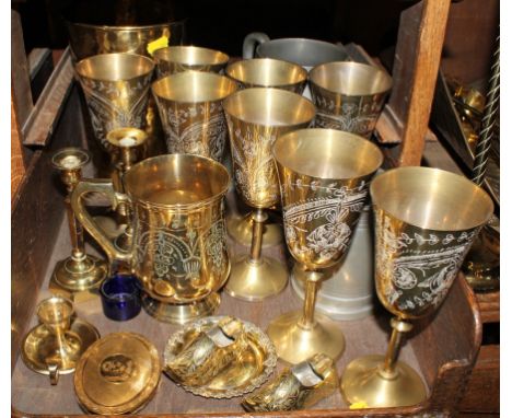 A variety of household brass utensils, to include goblets, tankards, candlestick holders, etc