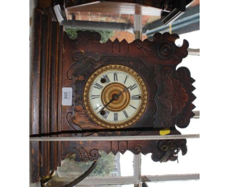 An early 20th century oak framed mantle clock, manufactured by The Ansonia Clock Company, New York, with profuse carving to t