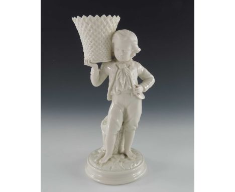 A Belleek first period bisque and glazed porcelain figural spill vase, modelled as a boy holding a basket on his shoulder, pr