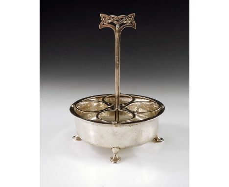 Archibald Knox for Liberty and Co., an Arts and Crafts silver egg stand or cruet, Birmingham 1900, the circular planished bod