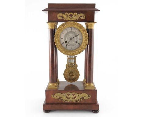 A French Charles X ormolu and flame mahogany portico clock, Empire style, signed Guyerdet, the 6 inch silvered dial engine tu