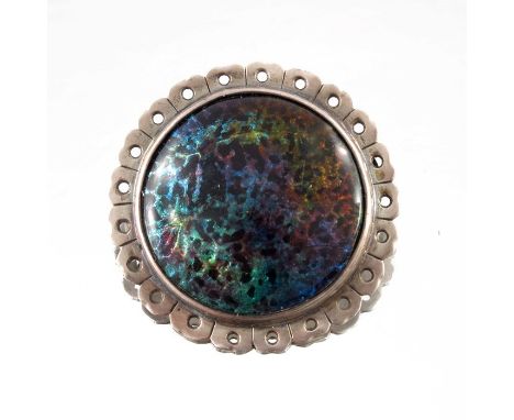 William Mark, an Arts and Crafts silver and enamelled brooch, Chipping Campden, circa 1912, the fire opal enamel cabochon wit