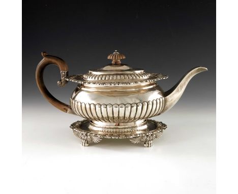 A George III silver teapot on stand, J E Terrey and Co., London 1817, squat ovoid form, half reeded, with everted rim, cast f