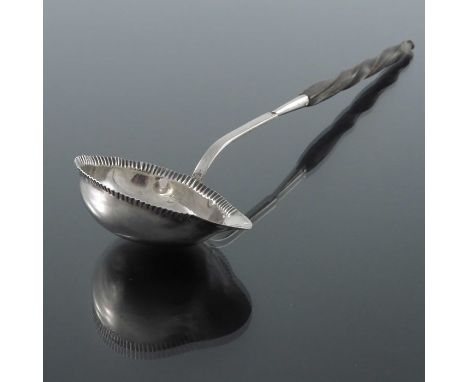 A French silver and horn ladle, Paris circa 1797, the boat shaped bowl with stamped gadrooning to the rim, 27cm long