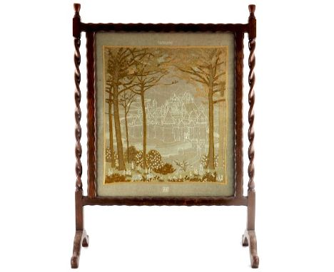 A 19th century oak firescreen with needlework panel and barley-twist supports, panel depicts kingdom of Torelore, monogrammed