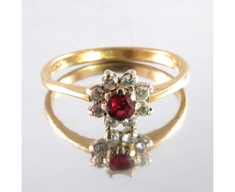 A ruby and diamond cluster ring on 18 carat gold band, approx size K