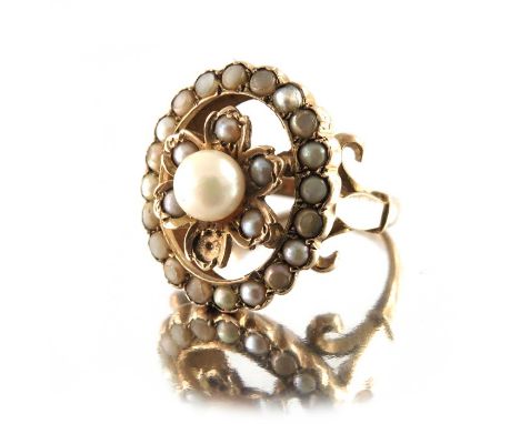 A Victorian gold and seed pearl ring, the 4cm diameter central pearl within floral setting and pearl studded frame, approx si