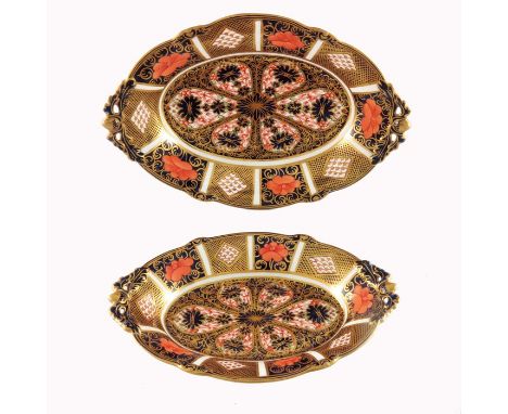 A pair of graduated Royal Crown Derby Imari 1128 oval dishes, twin handles, on four pierced acorn and leaf bracket feet, 26cm