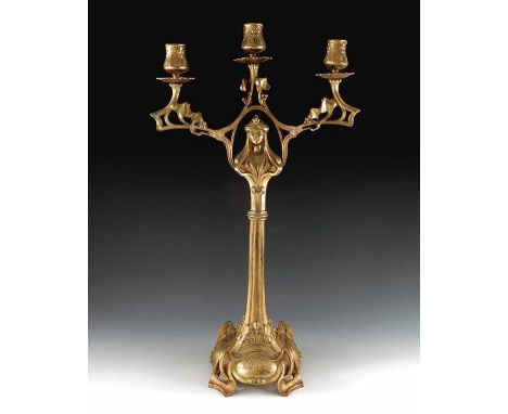 A Jugendstil gilt metal three light candelabrum, Art Nouveau style, cast foliate and open tendril design with central maiden 