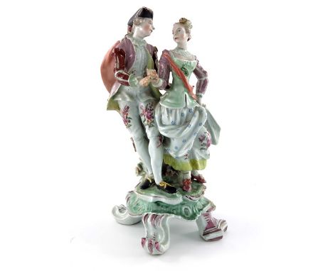 A Continental porcelain figure group, 18th century, modelled as a courting couple, on scroll bracket base, 27.5cm high 