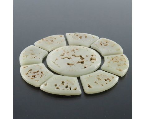 A Chinese reticulated carved jade sectional rosette, the central disc with peacocks and flowers, the eight segmented petals s