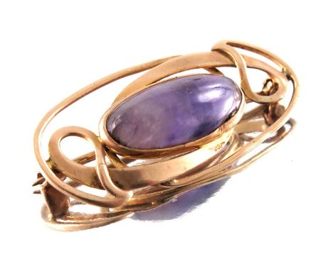 Archibald Knox for Liberty and Co., an Arts and Crafts amethyst and gold brooch, the central cabochon within an open knotted 